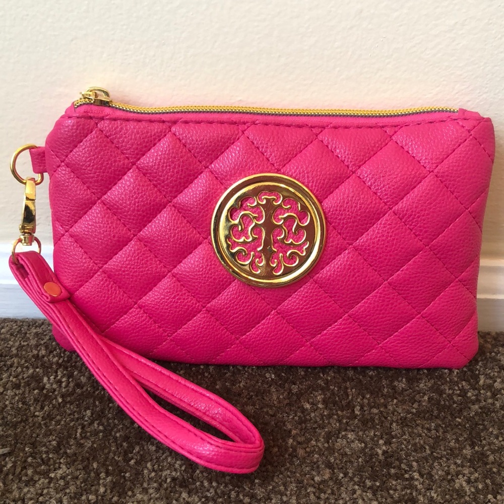 Pink wristlet with gold colored decoration and gold tone zipper